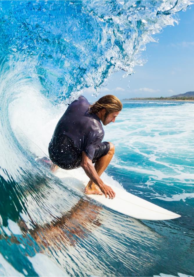 Man riding surfboard in wave